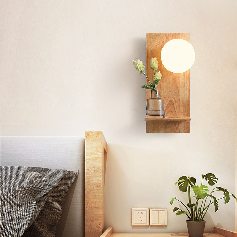 مصباح حائطي بسيط على شكل كرة زجاجية بقاعدة خشبية مربعة ومصباح واحد